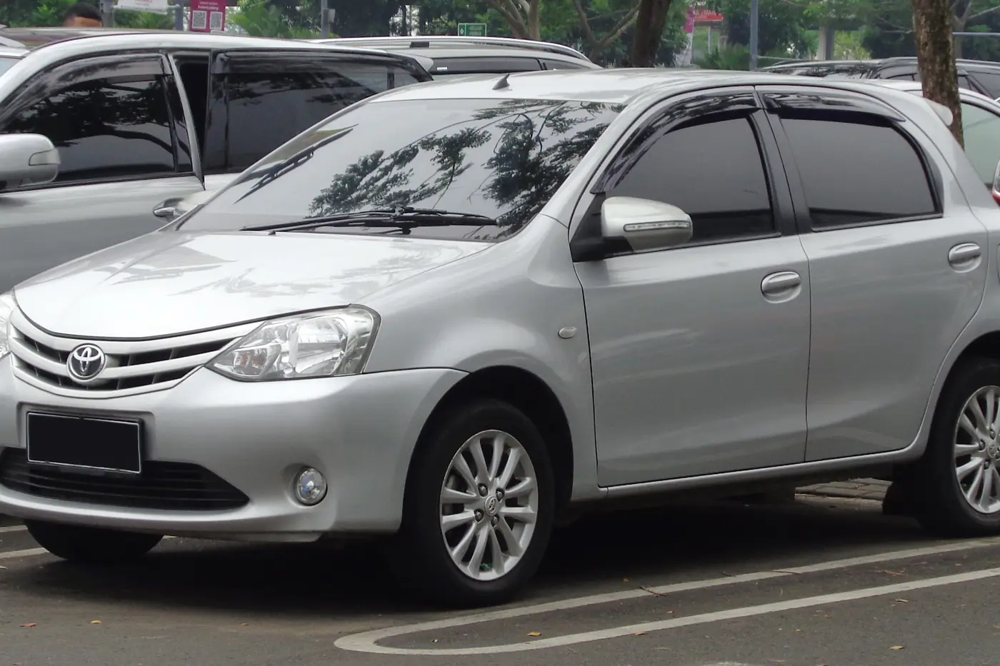 Silver Toyota Etios taxi parked outside Mangalore Central railway station